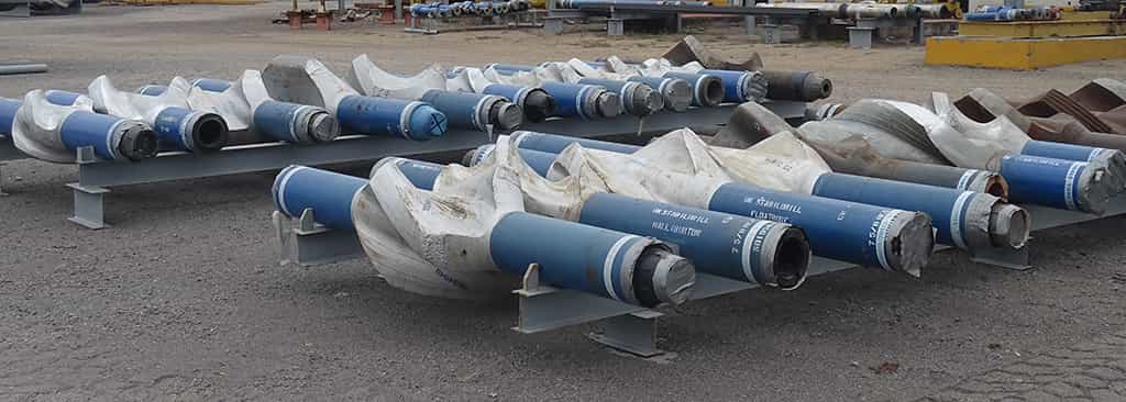 A row of blue downhole assembly pipes