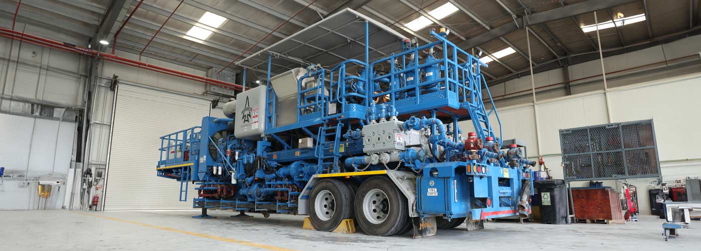 a blue cementing unit parked in a garage
